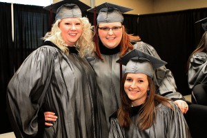 Morgan Currington of Vicksburg, sitting, Colie Hollowell of Vicksburg, standing left, and Clair Myers of Terry graduated from Hinds Community College on Dec. with degrees in dental assisting.