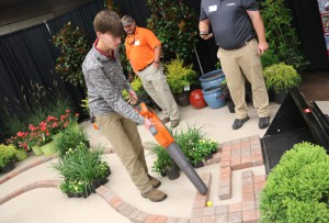 Jacob Alumbaugh of Brandon, a Hartfield Academy senior, uses a leaf blower to push a golf ball through a maze in hopes of winning at prize. He was among more than 1,200 area students who visited the Hinds Community College Career Exploration Day on Nov. 8.