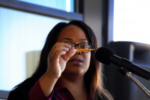 Dr. Ericka Davis, director of the Early Childhood Education program at Hinds Community College Jackson Campus-Academic/Technical Center, shows a small pencil to attendees of a ceremony March 31 to name the program's building for her predecessor, Dr. Mary Ann Greene. Davis showed the pencil and other items as an example of items Greene used frequently during her 33 years at Hinds. (Hinds Community College/Tammi Bowles)