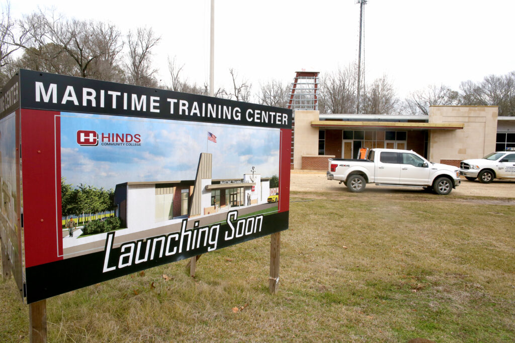 Construction sign in front of building: "Maritime Training Center Launching Soon"
